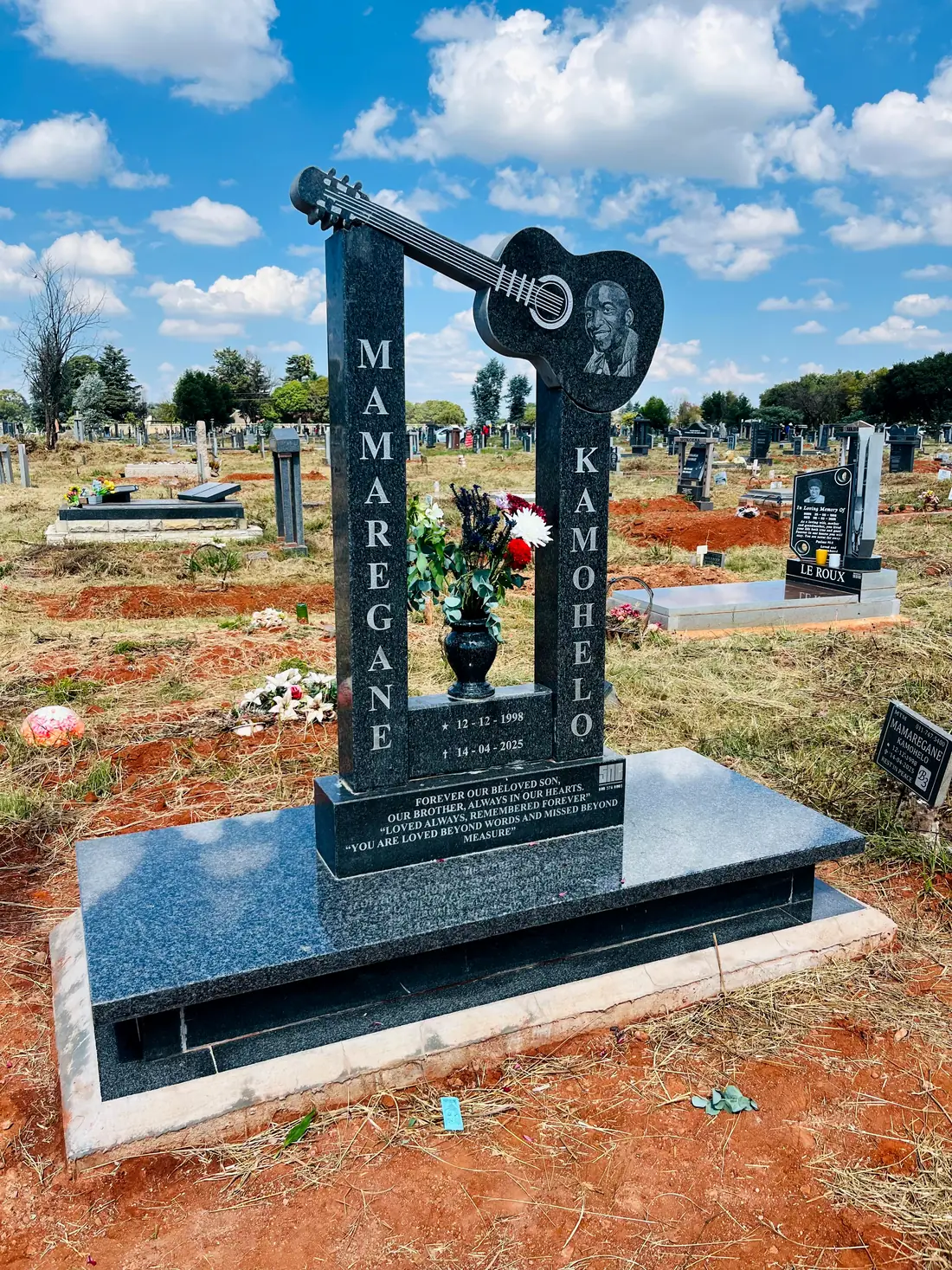 Custom granite memorial shaped with a guitar